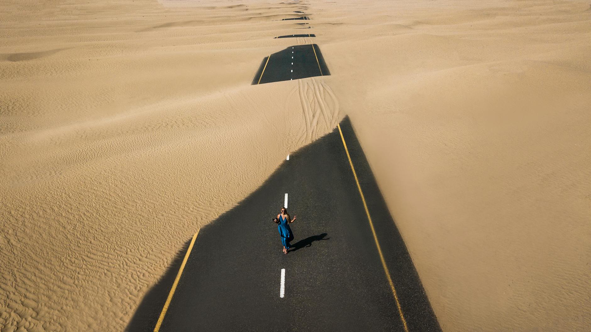 bird s eye view photography of road in the middle of desert